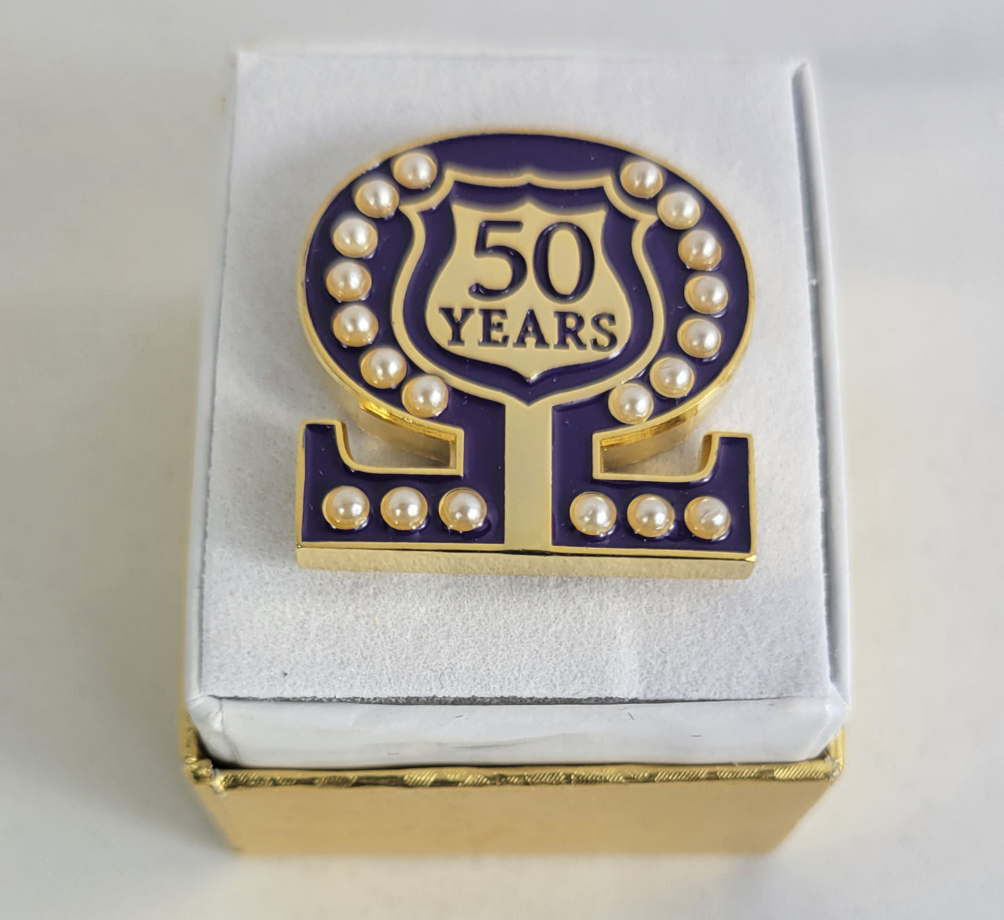 50 Year Omega Shield Baroque Gem Lapel Pin