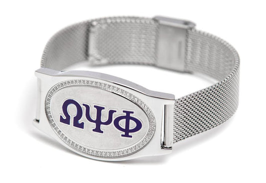Omega Psi Phi Legacy Bracelet featuring Greek letters ΩΨΦ in royal purple enamel on a brushed silver plaque with a woven silver mesh band.